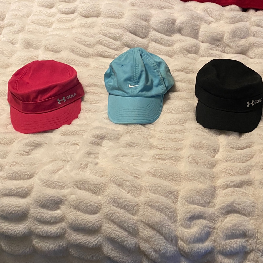 3 Women’s adjustable Golf hats- pink & black UA cadet style, blue Nike.